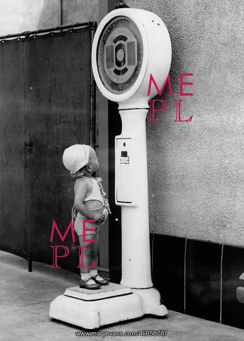 : A little boy is standing on the scales : A little boy is standing on the scales