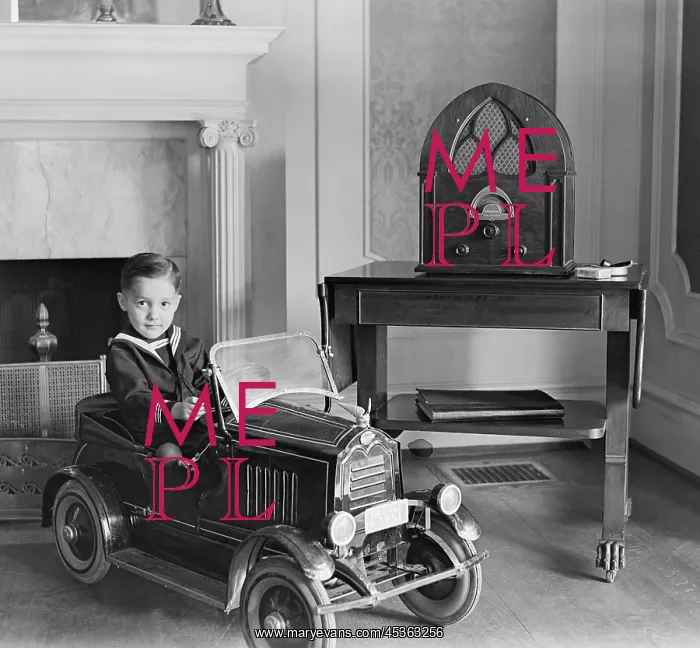 : Little boy in his toy automobile next to a state : Little boy in his toy automobile next to a state