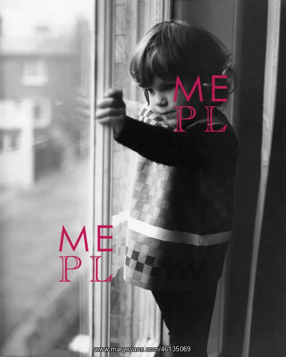 : Little girl looking through a window : Little girl looking through a window