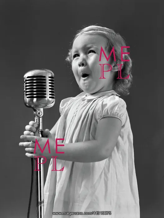  : Little girl making face singing into microphone