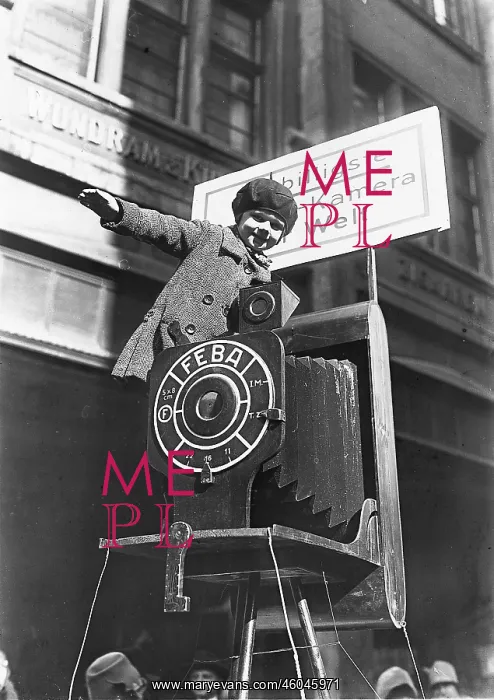 : Little Girl sitting on an oversized camera : Little Girl sitting on an oversized camera
