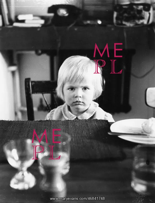 : Little girl sitting at a table : Little girl sitting at a table
