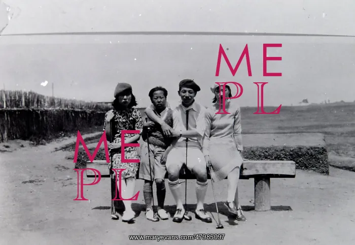 : Four local people on a golf course in the Far East : Four local people on a golf course in the Far East