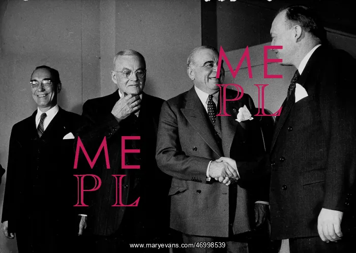 : Lord Ismay shaking hands with other politicians : Lord Ismay shaking hands with other politicians