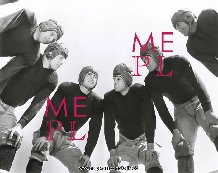 : Low angle view of football huddle : Low angle view of football huddle