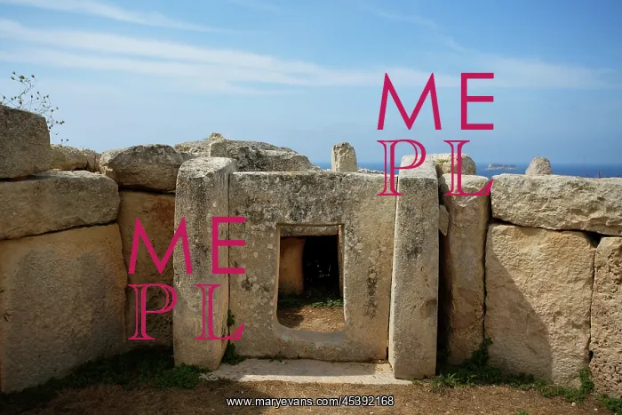 : Malta. Low angle view of a stone window frame in the Mnajdra Temple complex : Malta. Low angle view of a stone window frame in the Mnajdra Temple complex