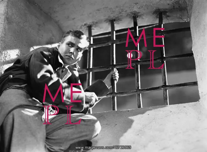 : Low angle view of a young man trying to escape from : Low angle view of a young man trying to escape from