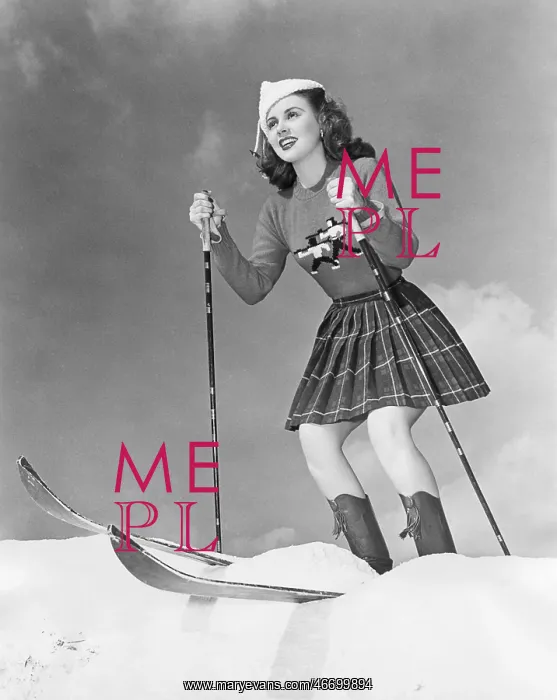 : Low angle view of young woman skiing : Low angle view of young woman skiing