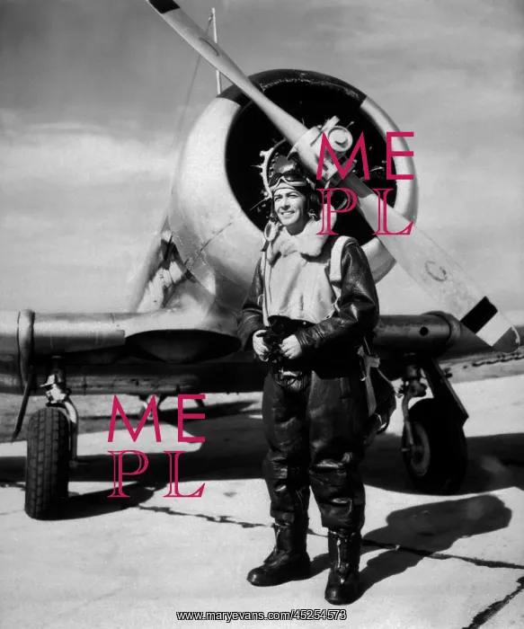 : Lt. Robert Taylor, USNR, standing beside a Navy : Lt. Robert Taylor, USNR, standing beside a Navy