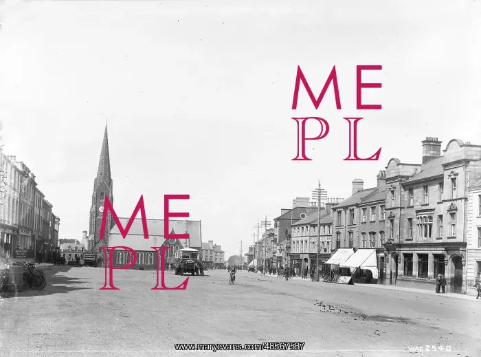  : Lurgan - a street scene with motor bus and people and shop fronts and church