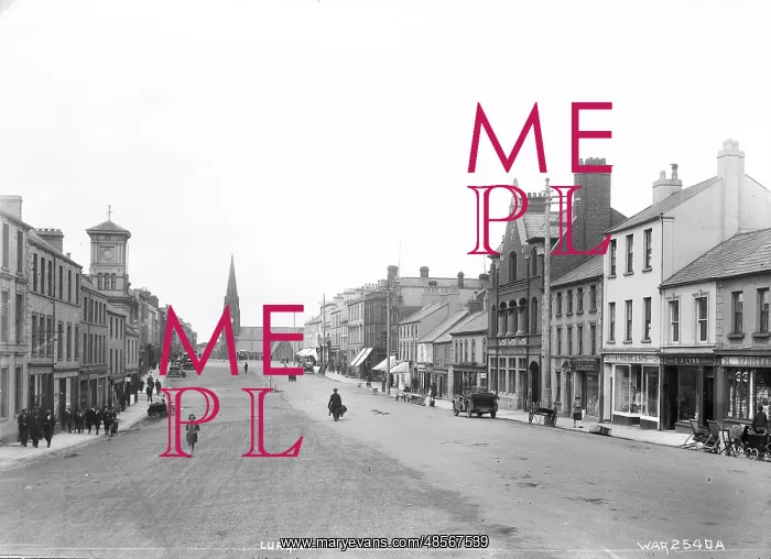 : Lurgan - a street scene with motor car and people and shop fronts and church : Lurgan - a street scene with motor car and people and shop fronts and church