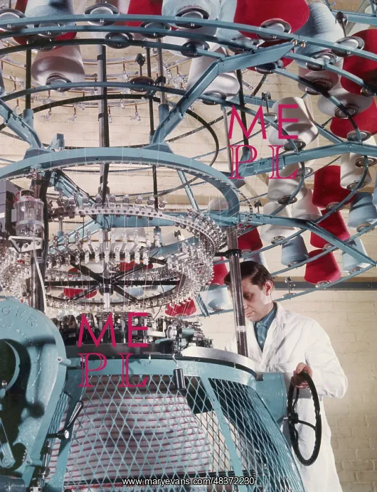 : A machine collects coloured yarn onto rolls : A machine collects coloured yarn onto rolls