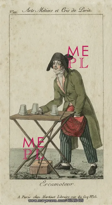: Magician performing the cup and balls trick : Magician performing the cup and balls trick