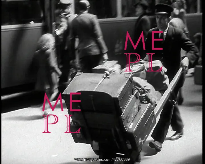 : A Male Train Station Porter Pushing a Sack : A Male Train Station Porter Pushing a Sack
