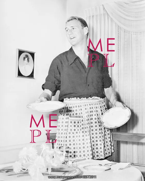  : Man in an apron setting the table