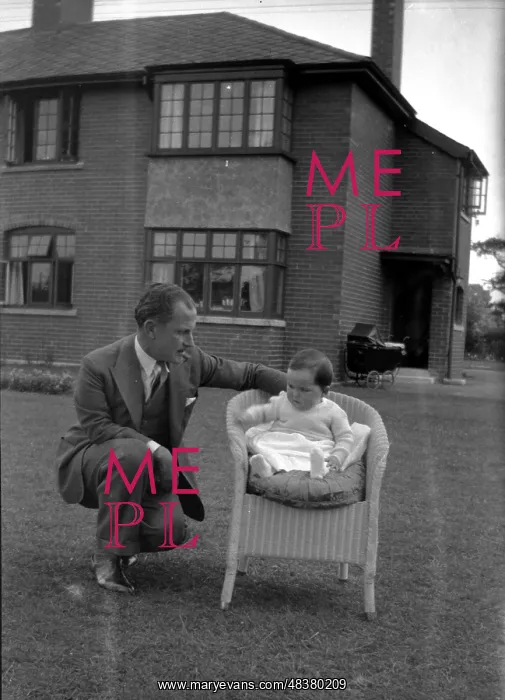 : Man and baby in a garden : Man and baby in a garden