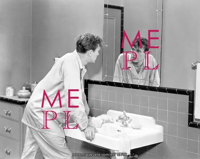  : Man in bathroom looking into mirror