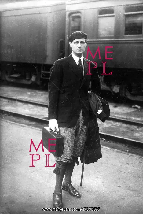 : Man in beret and knickerbockers at a station : Man in beret and knickerbockers at a station
