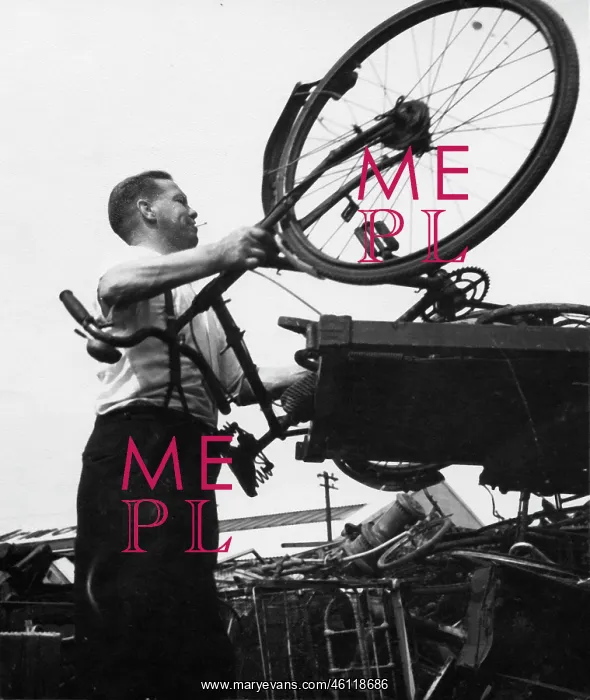  : Man with a bicycle in a junk yard