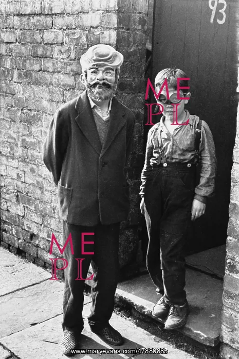 : Man and boy in costume at the back yard gate : Man and boy in costume at the back yard gate