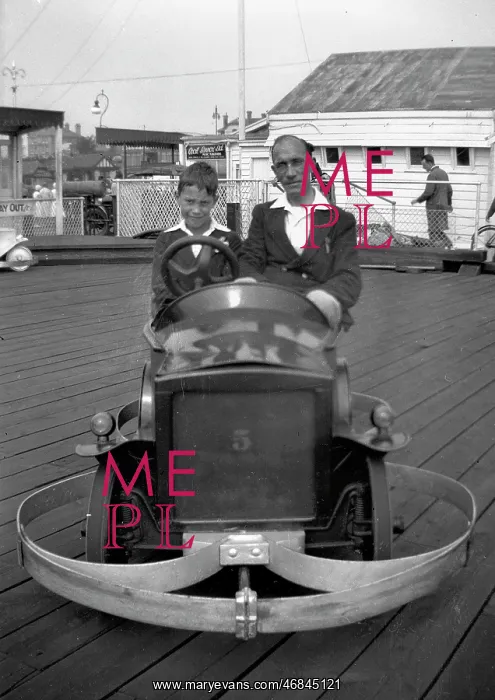 : Man and boy in dodgem car : Man and boy in dodgem car