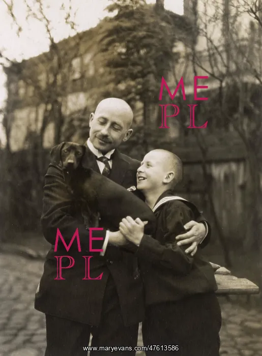  : Man and boy holding a dachshund