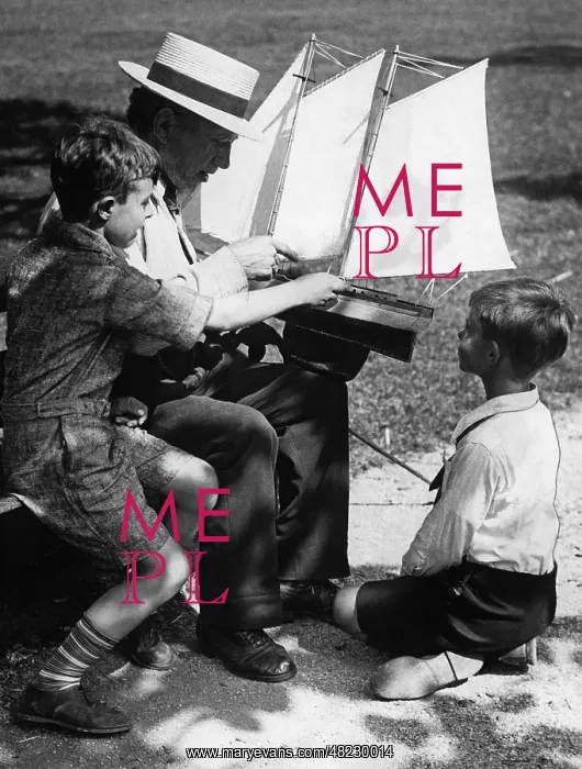 : Man and boys with a model of a ship, 1930s : Man and boys with a model of a ship, 1930s