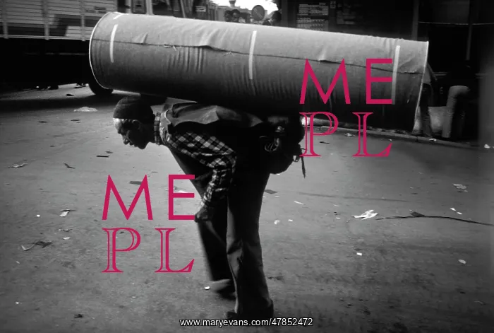 : A man carrying a huge roll of heavy material on his back : A man carrying a huge roll of heavy material on his back