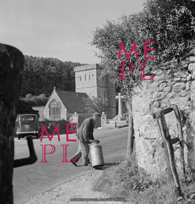 : Man carrying milk churn : Man carrying milk churn