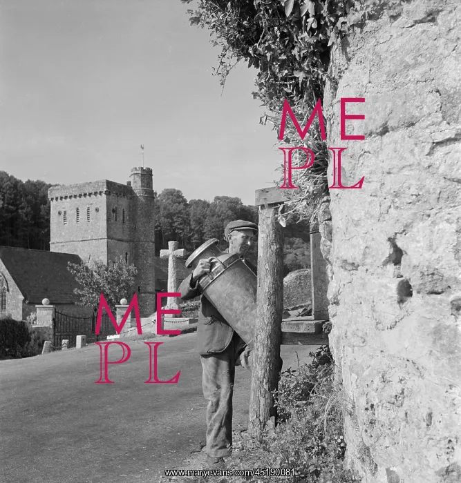 : Man carrying milk churn : Man carrying milk churn