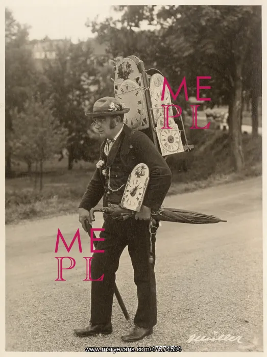  : A man carrying a back pack full of clock faces
