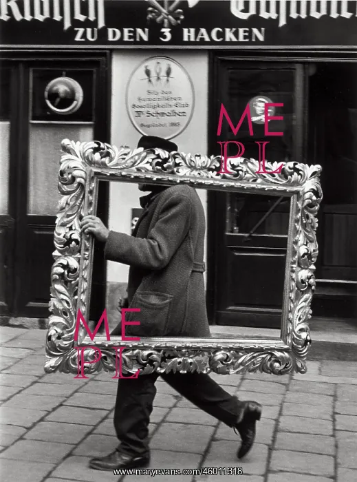 : Man carrying a picture frame : Man carrying a picture frame