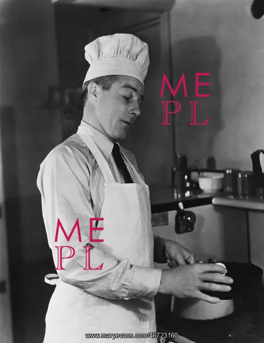 : Man in chef hat and apron cooking : Man in chef hat and apron cooking