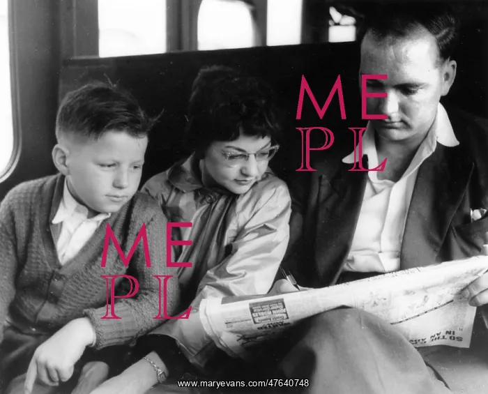  : Man and two children doing the crossword on a train
