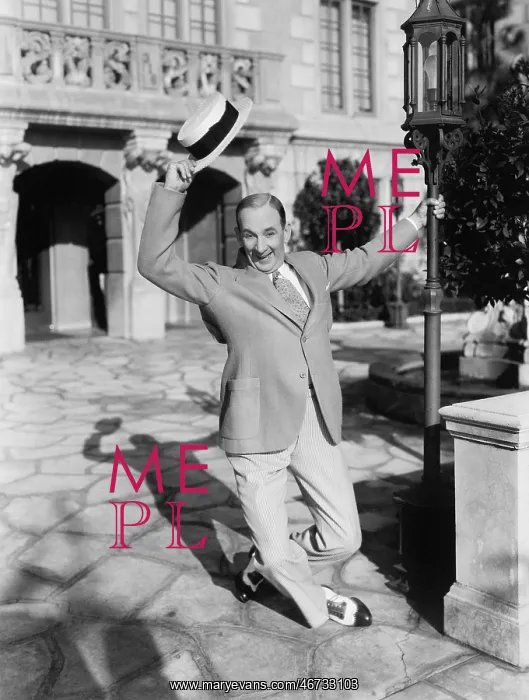 : Man dancing in the street waving his hat : Man dancing in the street waving his hat