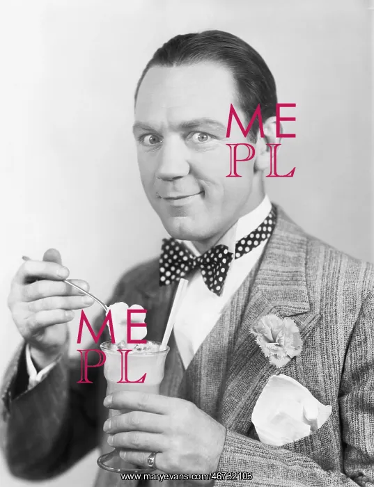 : Man eating an ice-cream out of a glass with a straw : Man eating an ice-cream out of a glass with a straw
