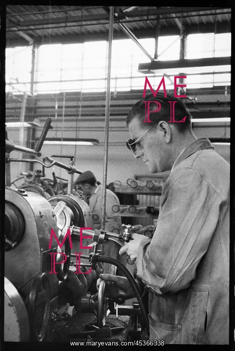 : A man engaged in the manufacture of glass tubes : A man engaged in the manufacture of glass tubes