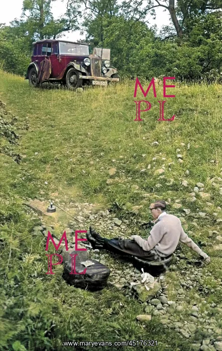 : Man in a field with parked car : Man in a field with parked car