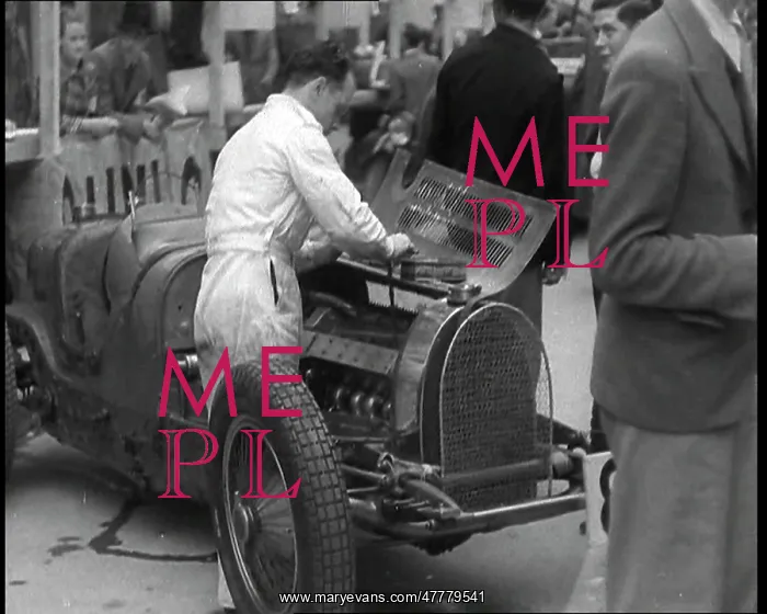 : Man Fixing a Racing Car : Man Fixing a Racing Car