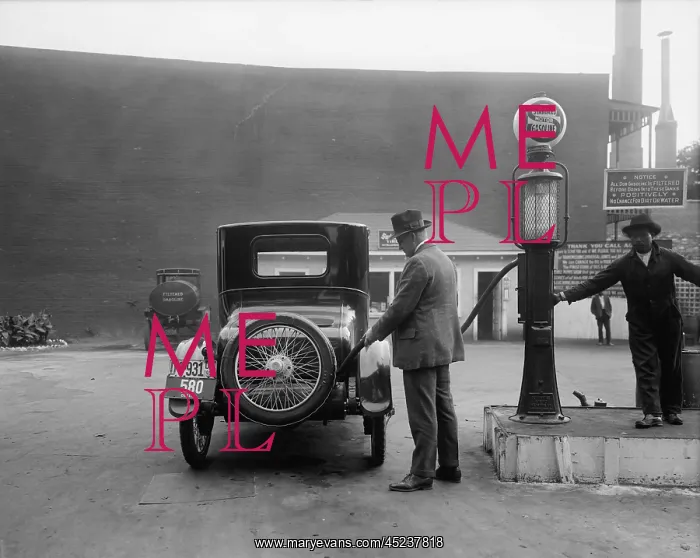 : Man fueling his car at a self-service Standard ? : Man fueling his car at a self-service Standard ?