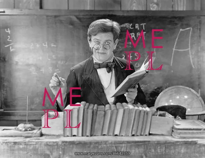 : Man with glasses teaching in a classroom : Man with glasses teaching in a classroom