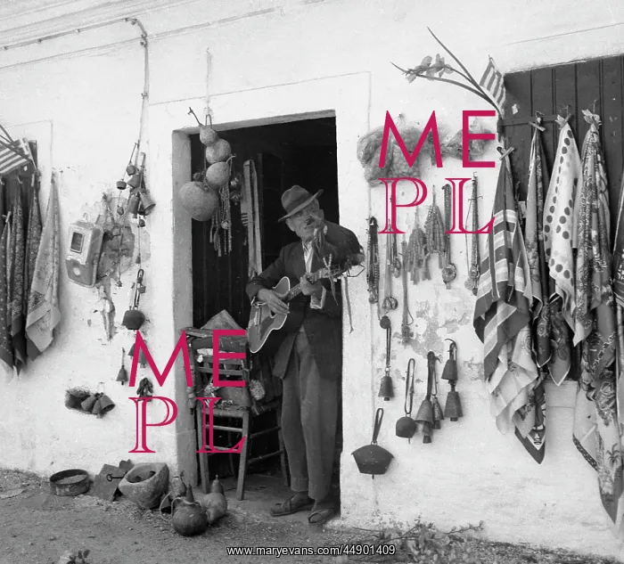 : Man with guitar in the doorway of a gift shop : Man with guitar in the doorway of a gift shop