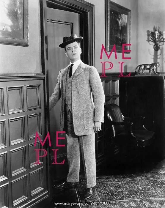  : Man with hat looking silly walking into a room