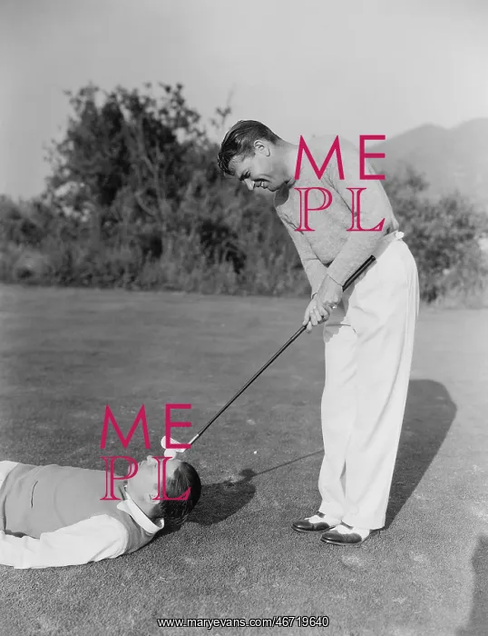 : Man hitting golf ball on mans forehead : Man hitting golf ball on mans forehead