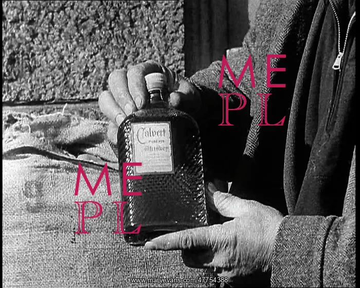: A Man Holding A Bottle of Liquor : A Man Holding A Bottle of Liquor