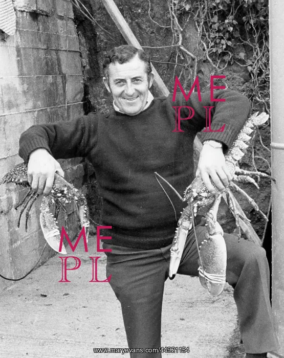  : Man holding two large lobsters