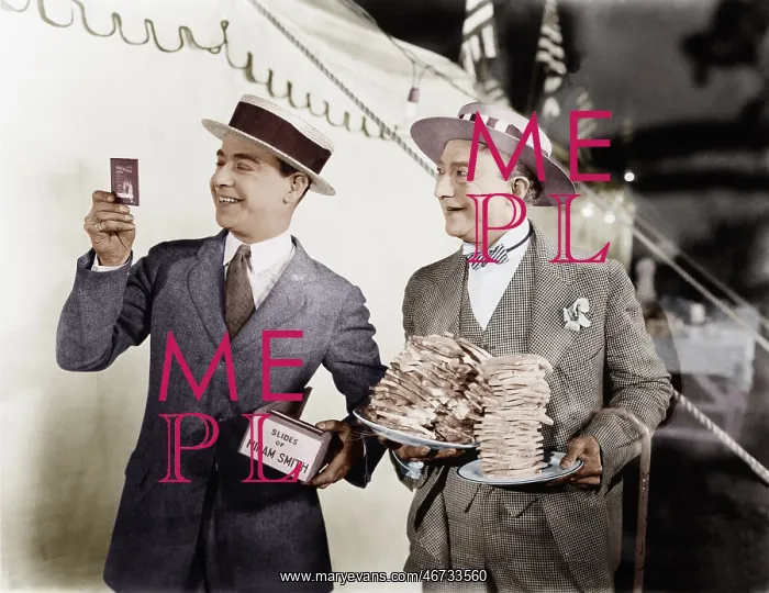 : Man holding plates of sandwiches with a man looking : Man holding plates of sandwiches with a man looking