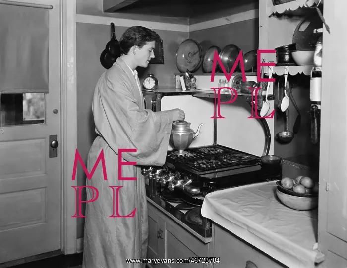 : Man in a kitchen brewing a pot of coffee : Man in a kitchen brewing a pot of coffee