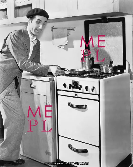 : Man in a kitchen preparing food : Man in a kitchen preparing food