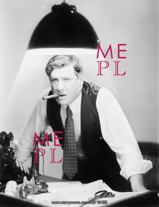 : Man leaning over a desk with a ceiling light shining on him : Man leaning over a desk with a ceiling light shining on him